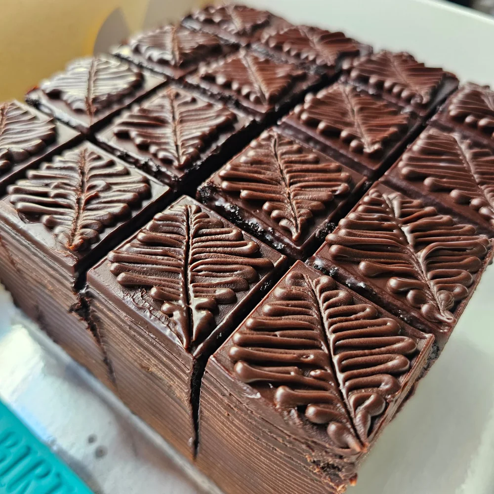 Moist chocolate cake finished with rich chocolate ganache by Amour Desserts in Melbourne