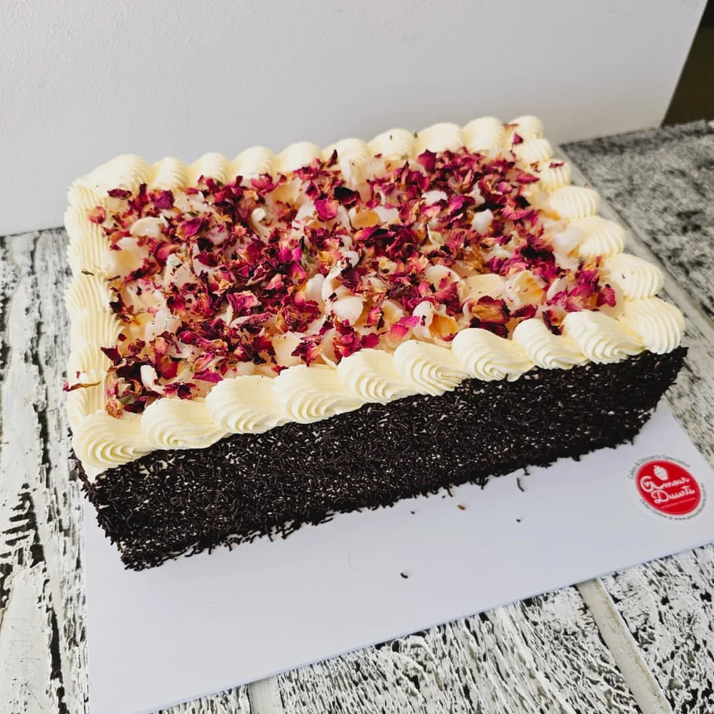 Rose sponge cake with lychee buttercream and dried rose petals by Amour Desserts